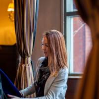 Woman adjusting faculty's uniform